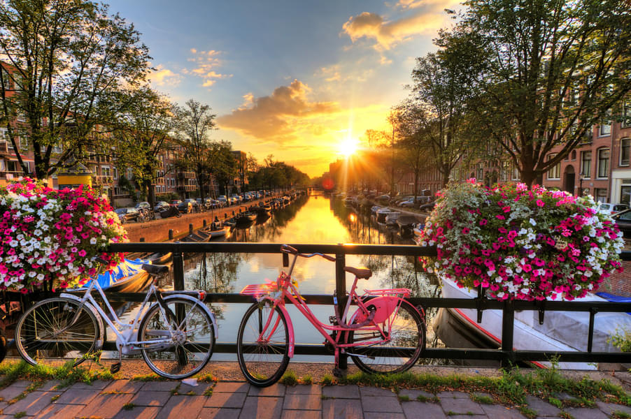 Visit the the city of Amsterdam known for its canals, and bicycles, 