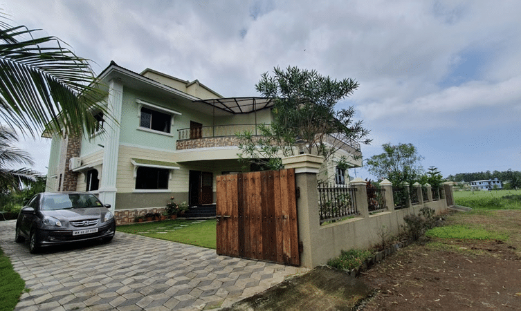 Aerial view of the villa with well maintained lawn and parking space