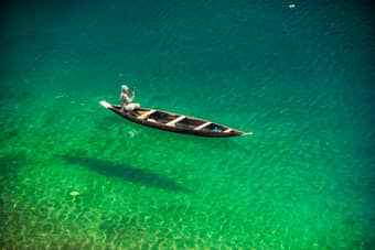 At Dawki, relax in the crystal clear waters while boating