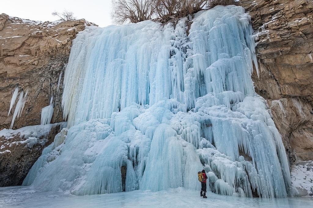Explore the icy charm of Drung waterfall , transformed into a winter wonderland with its frozen cascade.