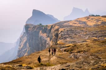 Trekkers hiking towards Konkankada cliff