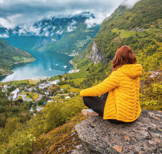 Woman admiring the views of Norwegian Geiranger fjord