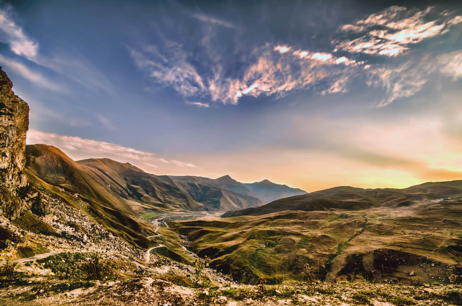 Scenic view of rolling hills and rugged mountain landscape in Azerbaijan.