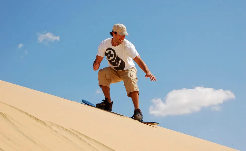 Grab your board and hit the dunes for an unforgettable sandboarding experience