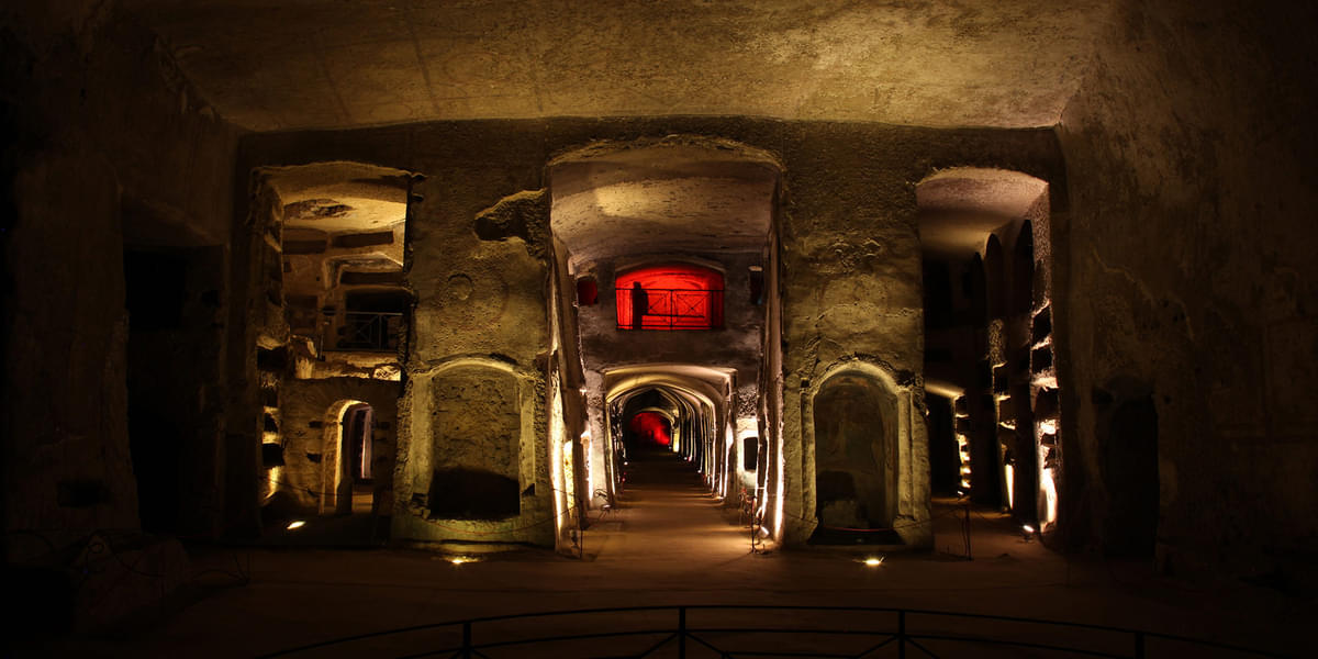 Walk into the ancient underground burial chambers of Catacombs of San Gennaro, revealing centuries of history