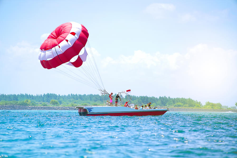 Feel the thrills of parasailing over the water
