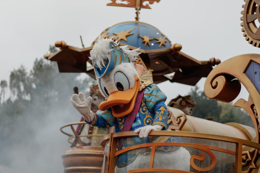 Wave back at Donald Duck during the parade show