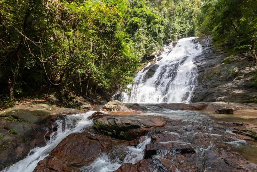 Listen to the sounds of running water and stand under Ton Prai Waterfall 