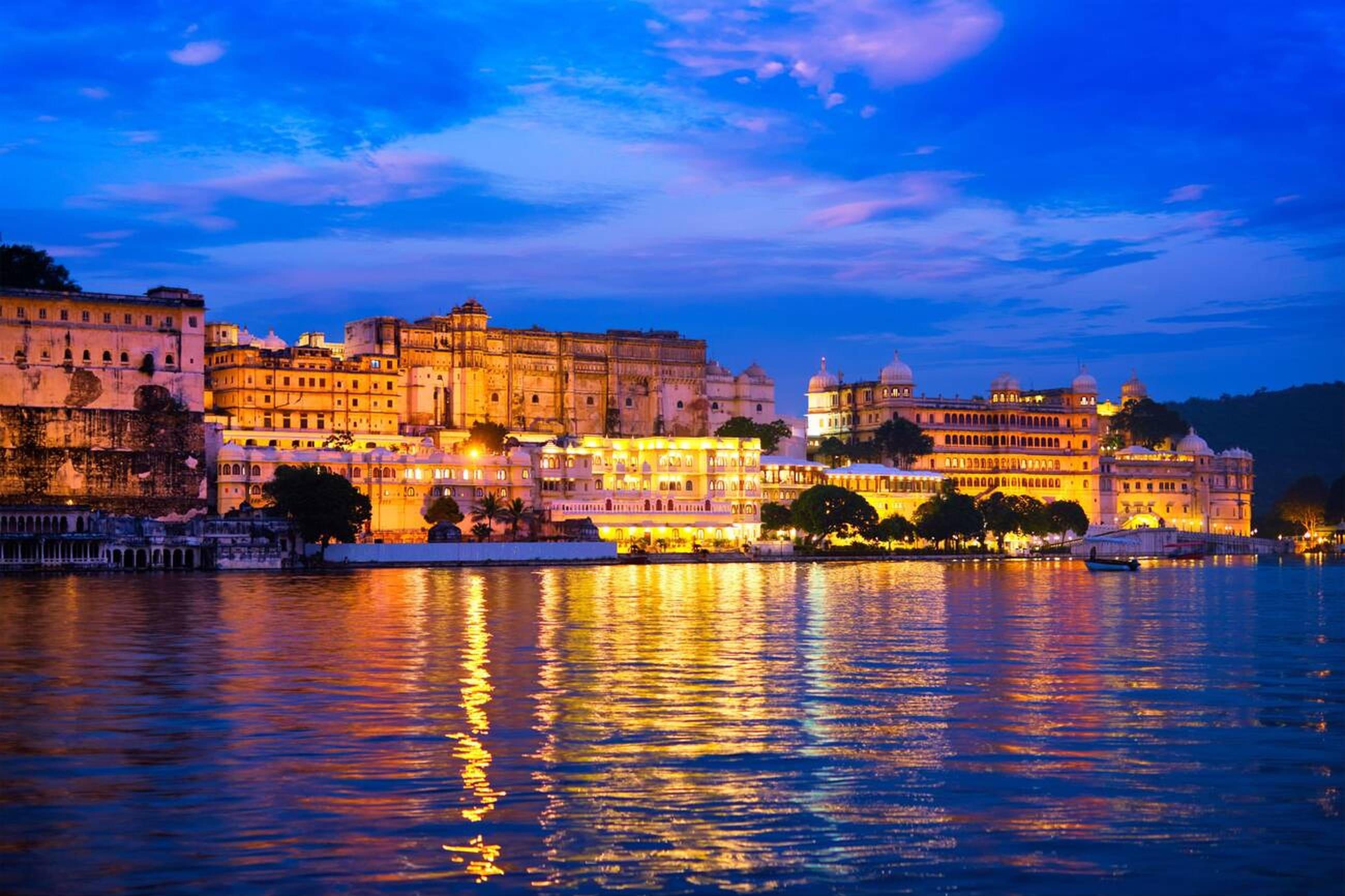 Stunning golden hues of City Palace and Pichola lake in Udaipur, Rajasthan