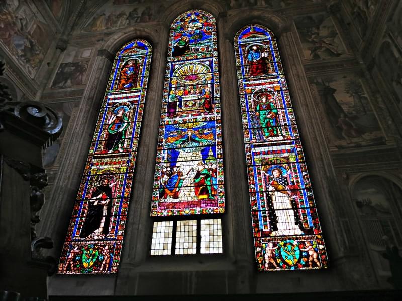 Gaze in awe at the vibrant hues of the stained glass windows