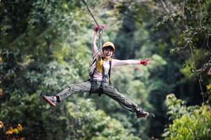 7sm24mj2u2ddvyb9di1t8s8sqeil stock photo freedom woman tourist wearing casual clothing on zip line or canopy experience in laos rainforest 540820594