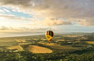 Soar over Byron Bay as the sun paints the sky in gold.