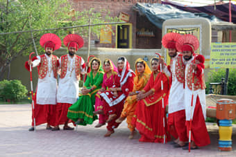 Local dance group posing for camera in their vibrant traditional dresses