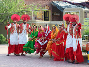 Local dance group posing for camera in their vibrant traditional dresses