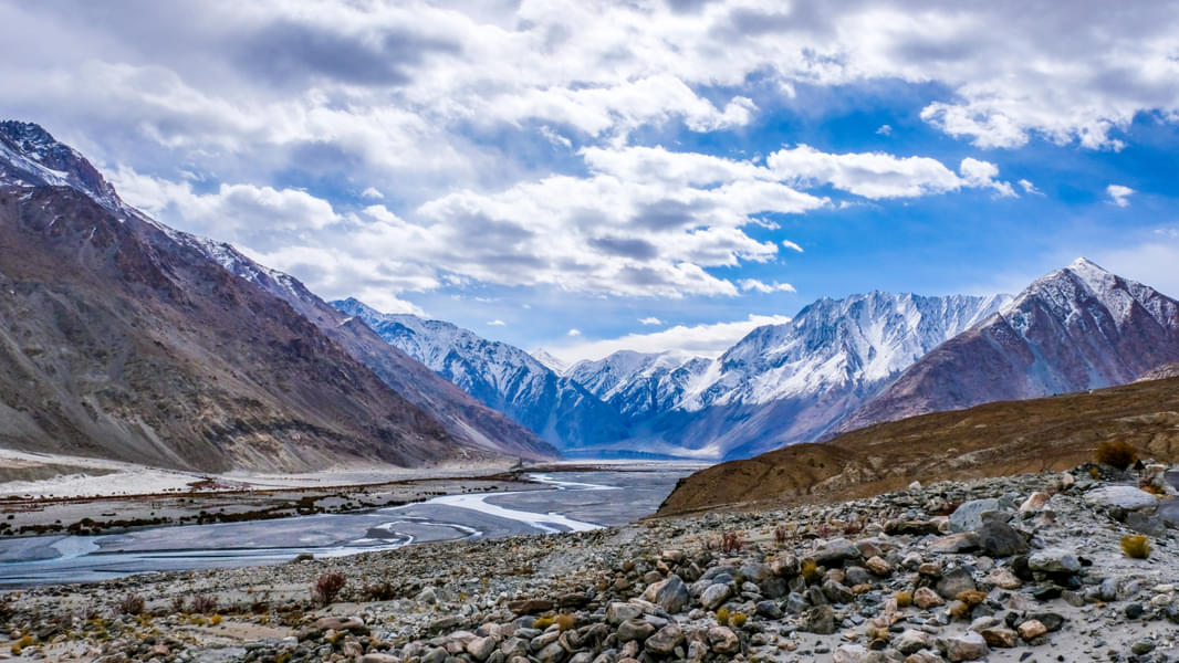 Admire the snow laden Himalayas, the river and the enchanting landscape