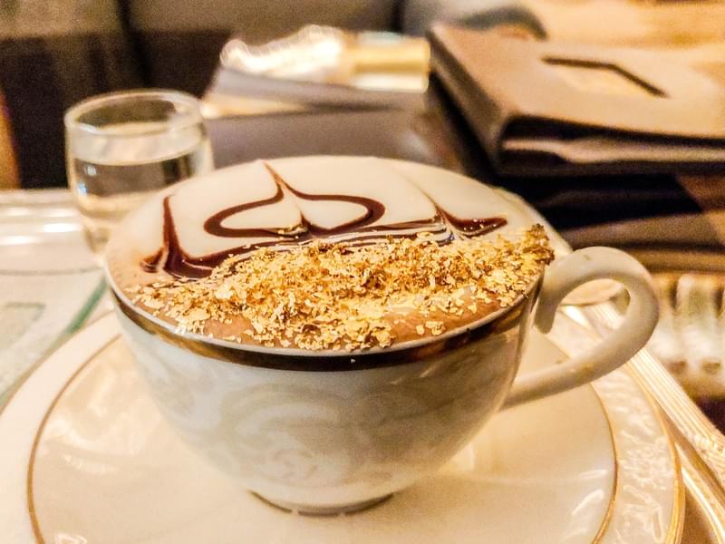 Savor the exquisite flavor of complimentary golden coffee at the Emirates Palace