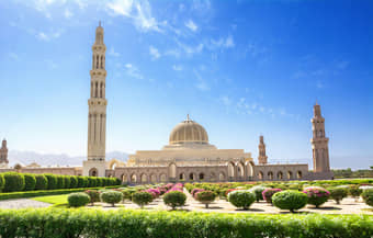 Marvel at the stunning architecture of the Muscat Grand Mosque