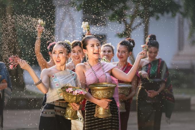 Solar New Year Celebration- Young girls splashing water on tourists