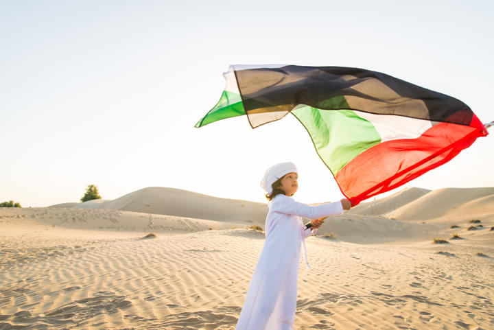 kid with UAE national flag