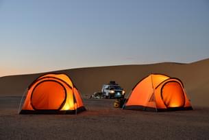 Sleep under the stars in the heart of the Sam Sand Dunes desert