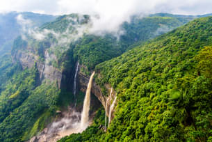 Experience the awe-inspiring Nohkalikai Waterfalls as it plunges down the cliff