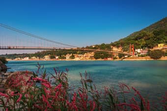 Explore serene Ram Jhula offering views of the Ganges and surrounding hills