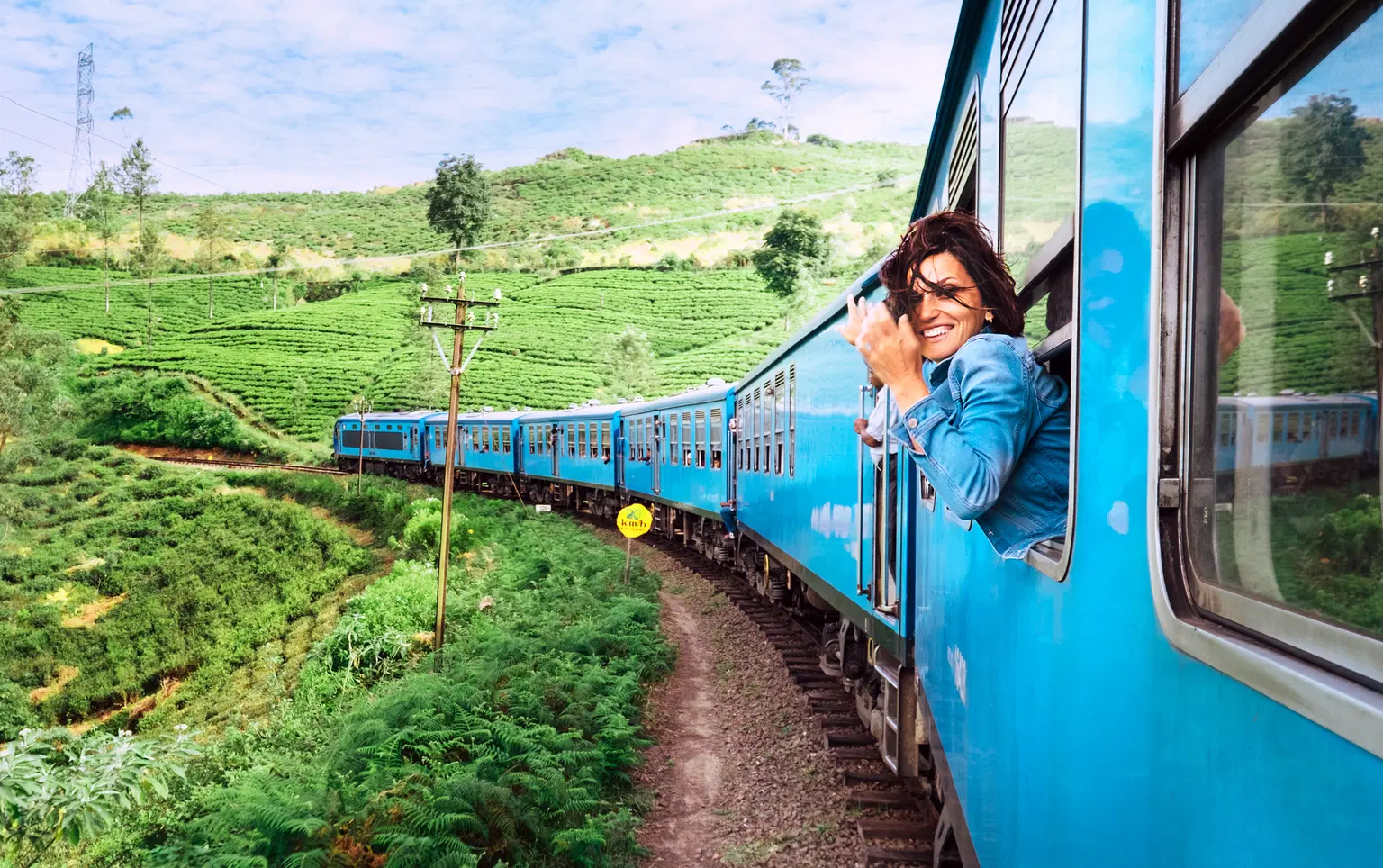 Scenic train journey through lush greenery on popular Sri Lanka packages