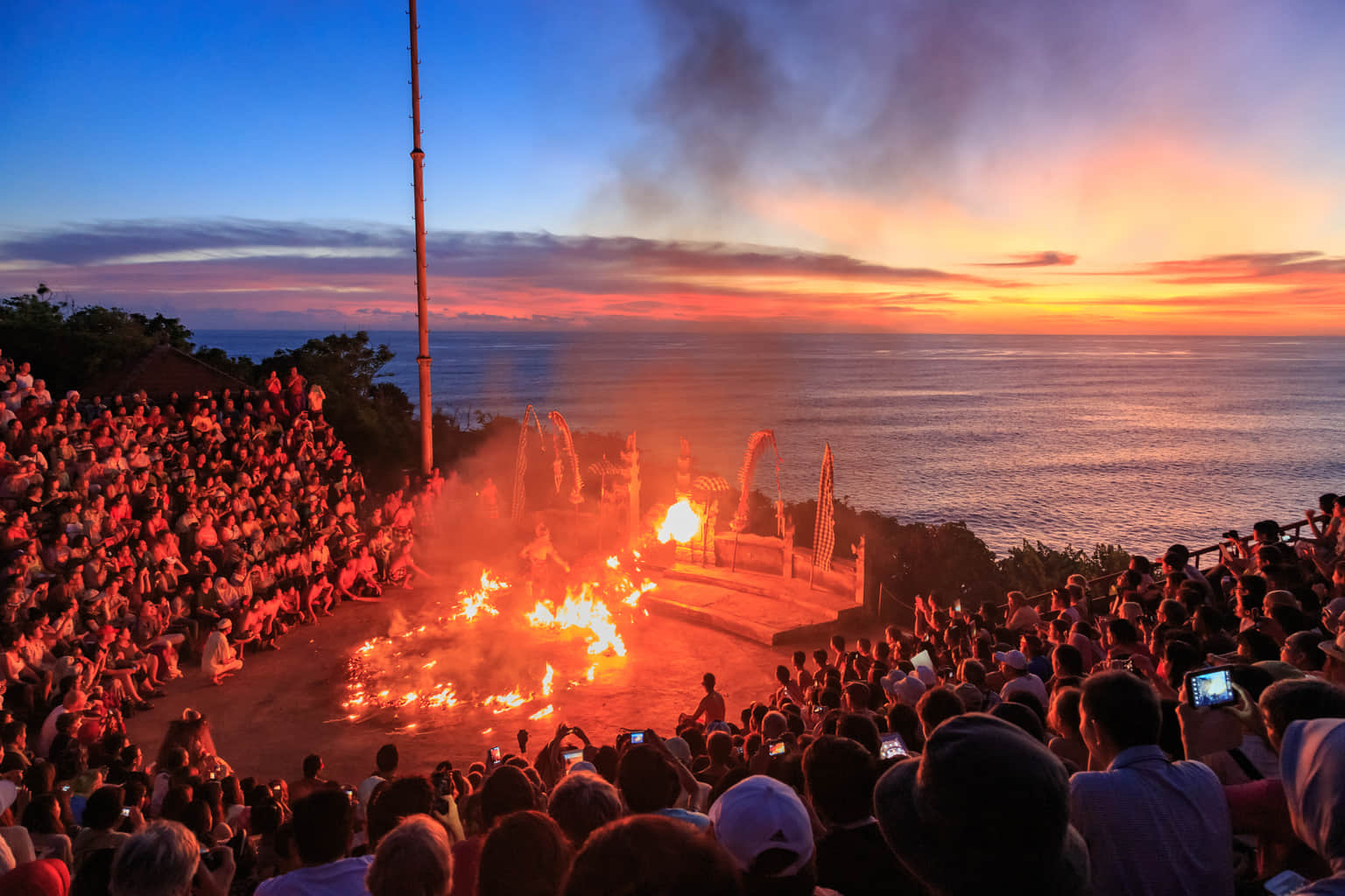Visitors enjoying the famous Kecak Fire Dance in Uluwatu