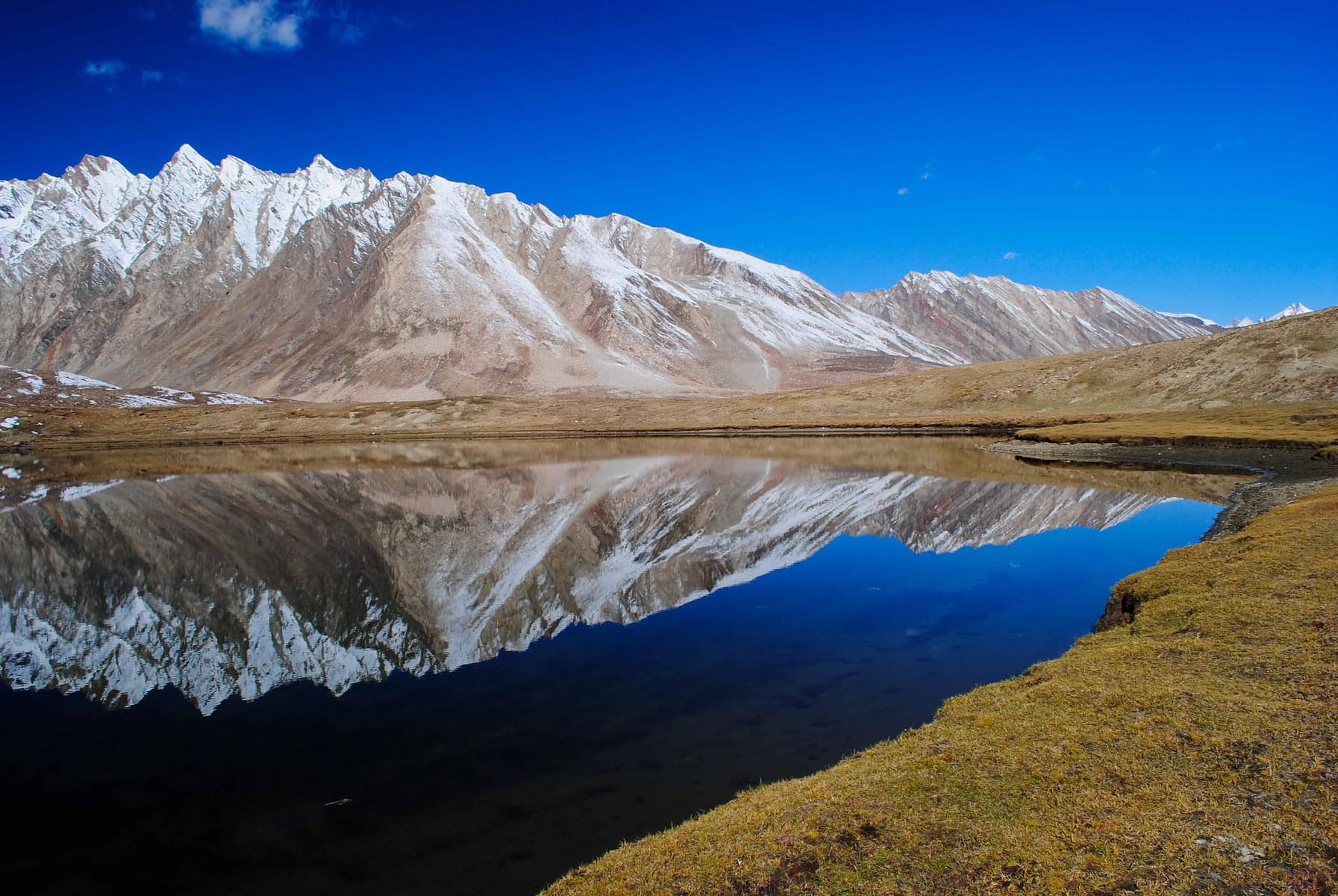 Be mesmerized by the reflection of barren hills in the beautiful lake