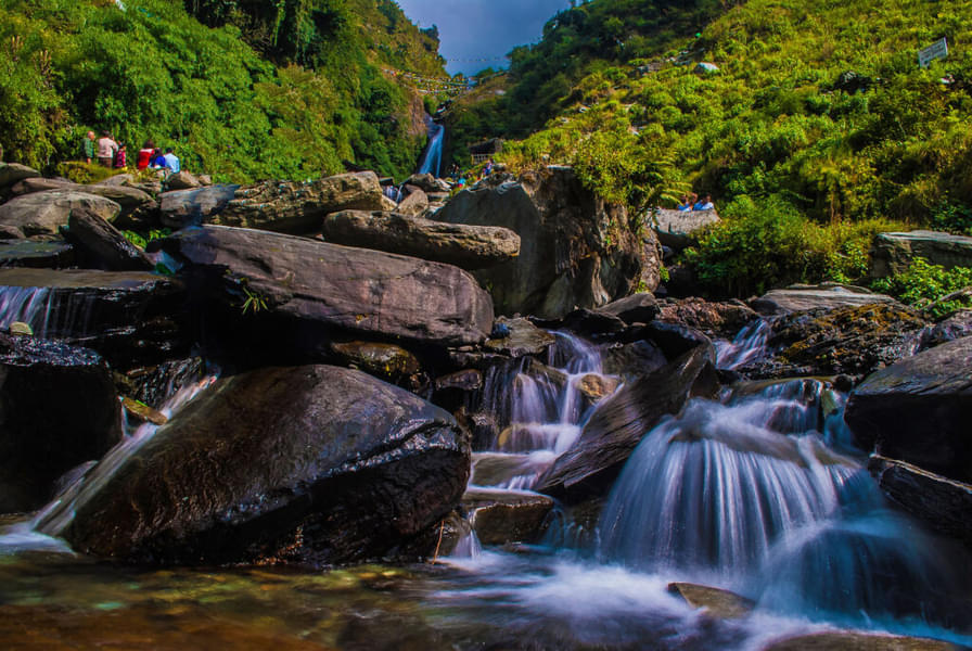 Enjoy the serenity of several little waterfalls from the rocks during the trek