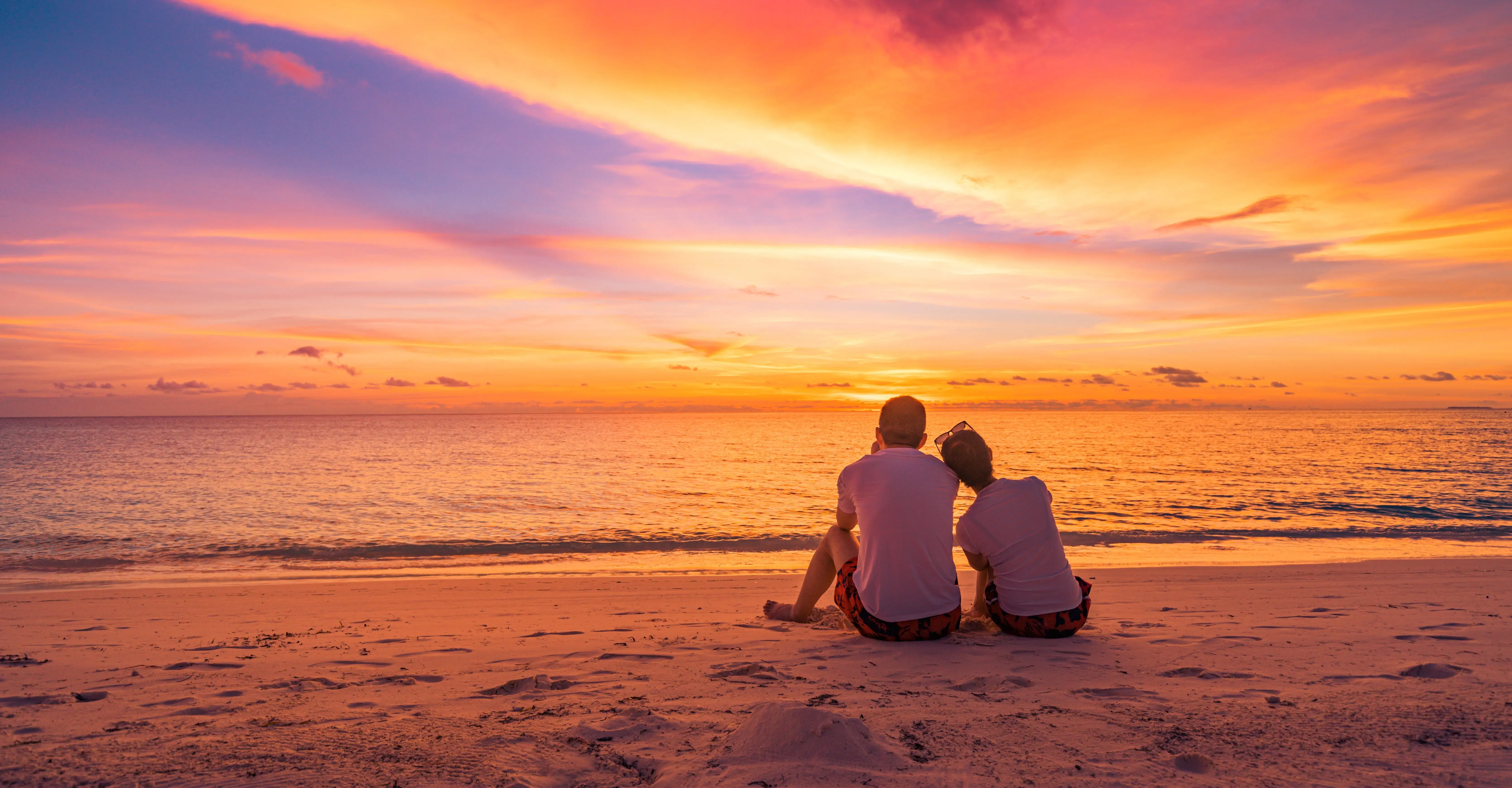 Couple enjoying sunset at the beach