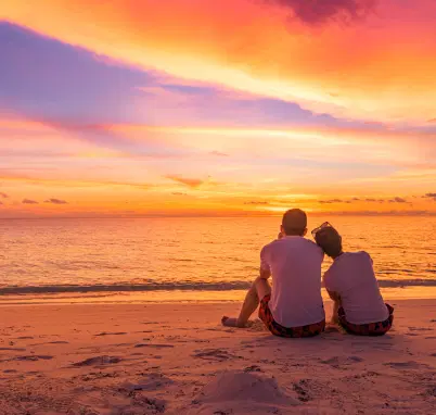 Couple enjoying sunset at the beach