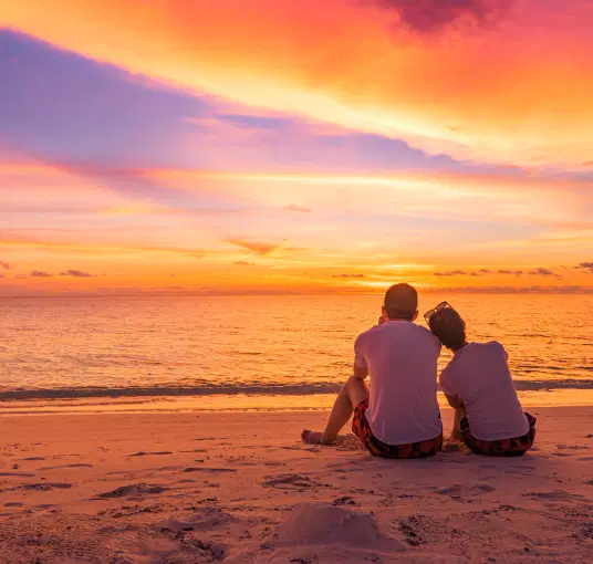 Couple enjoying sunset at the beach