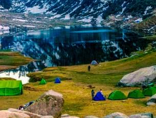 Enjoy your stay at Reoti campsite and look at the scenic views of Dhauladhar peaks and thick plants 