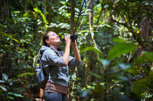 Spot rare birds and wildlife using binoculars on the trek through the tropical dry evergreen forest