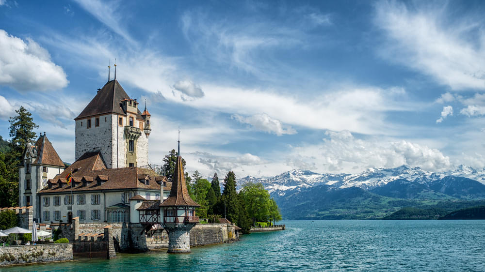 View the enchanting Oberhofen Castle on the shores of Lake Thun