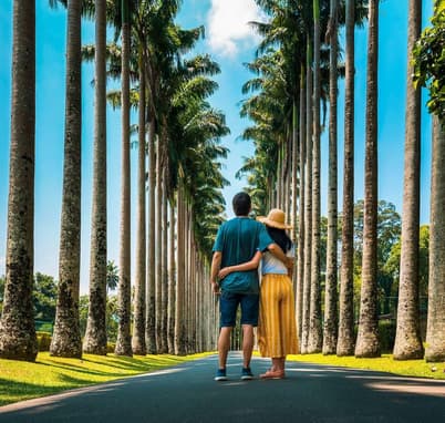 Couple visiting palm alley at Royal Botanical Gardens in Kandy