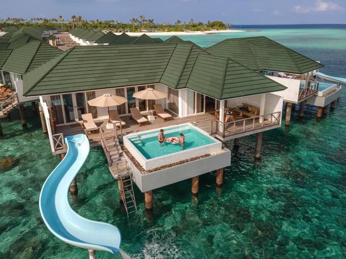 Couple enjoying their breakfast at the Water Villa with Pool and Slide