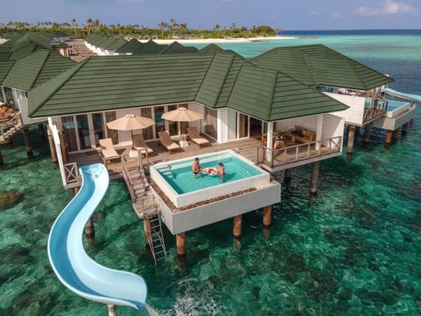 Couple enjoying their breakfast at the Water Villa with Pool and Slide