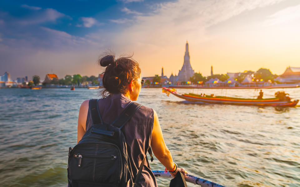 Watch the sunset over the Chao Phraya River