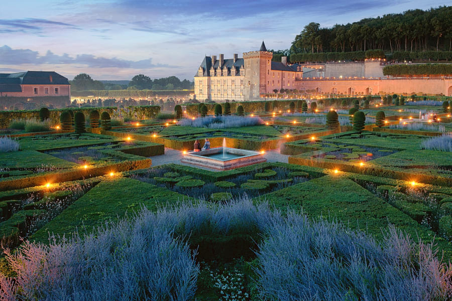 Enjoy beautiful views of Chateau de Villandry as you stroll through the gardens