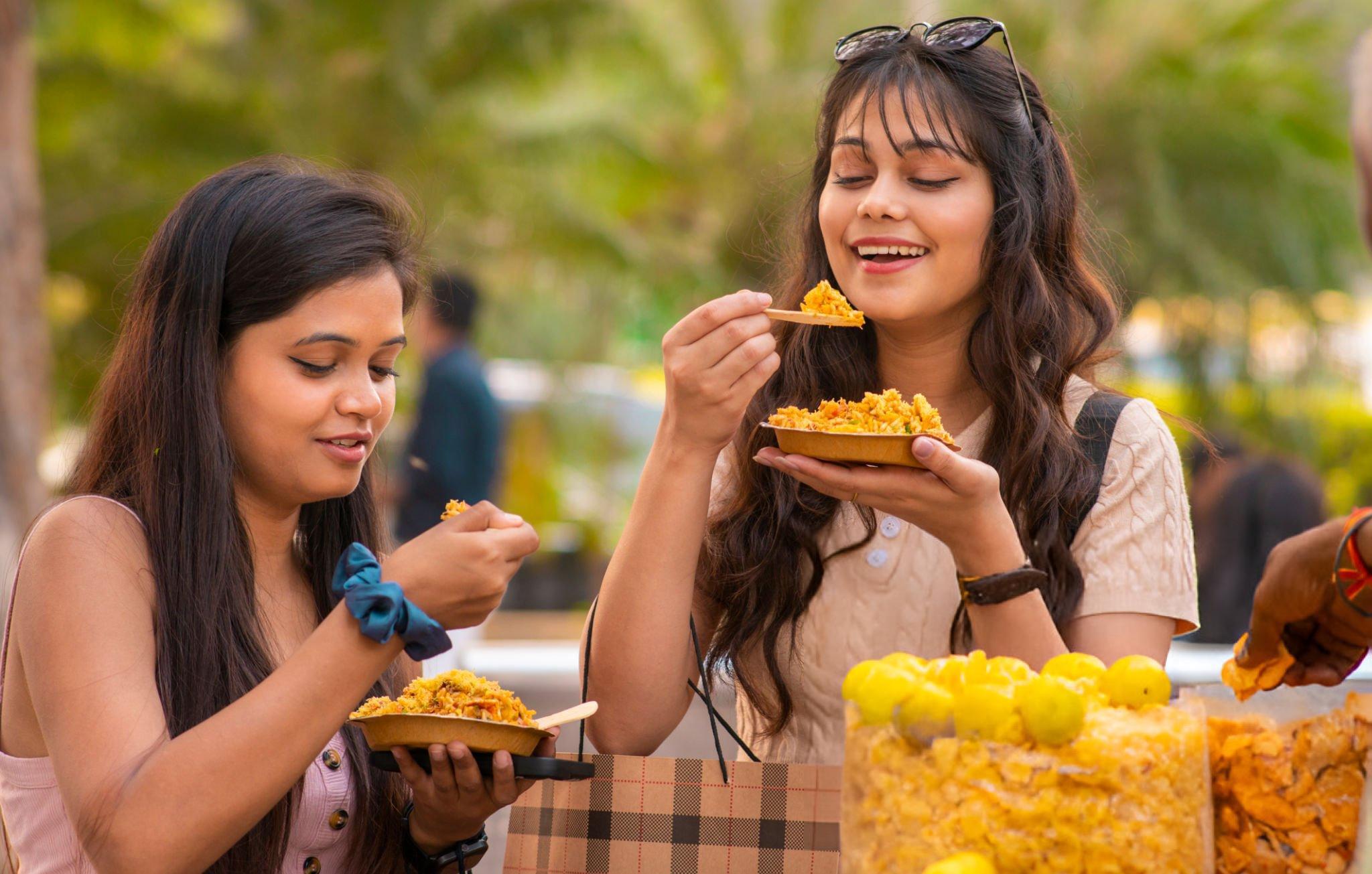 Girls enjoying bhelpuri on the street