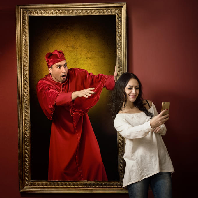 Visitor striking a selfie pose with the 3D painting