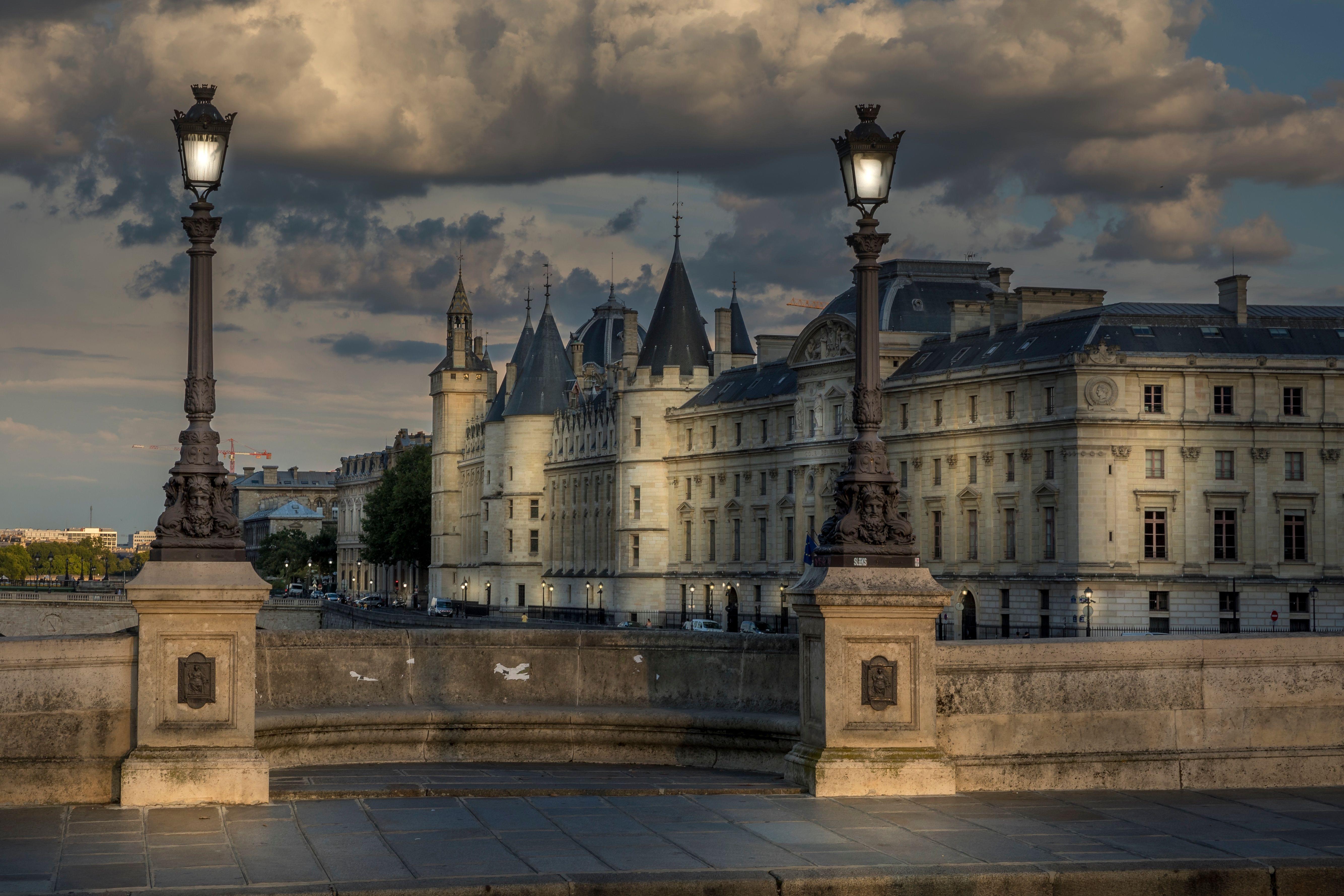 View of Conciergerie palace at night in Paris