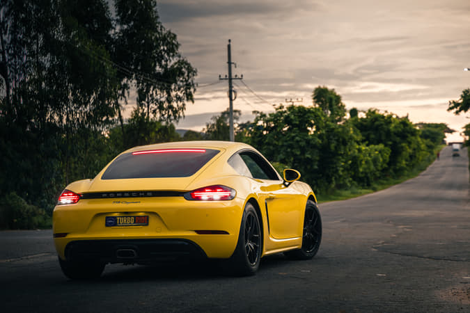 Take the wheel of the legendary Porsche 718 Cayman and conquer the open road