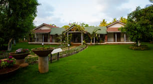 Entrance view of the homestay with lush green lawn
