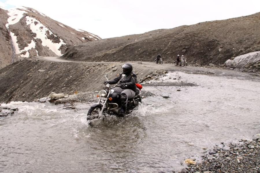 Feel the thrill of adventure as you explore the rugged terrain of Ladakh on your trusty bike