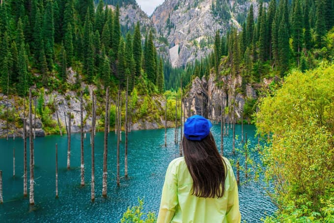 Woman admiring the beautiful Lake Kaindy