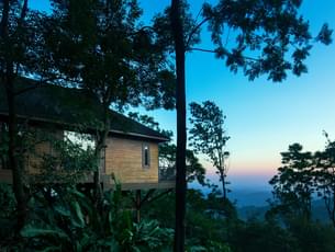 Stay in cottages overlooking the green valleys of Western Ghats