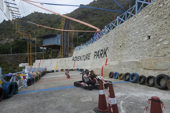 Race through winding tracks surrounded by misty Mussoorie hills